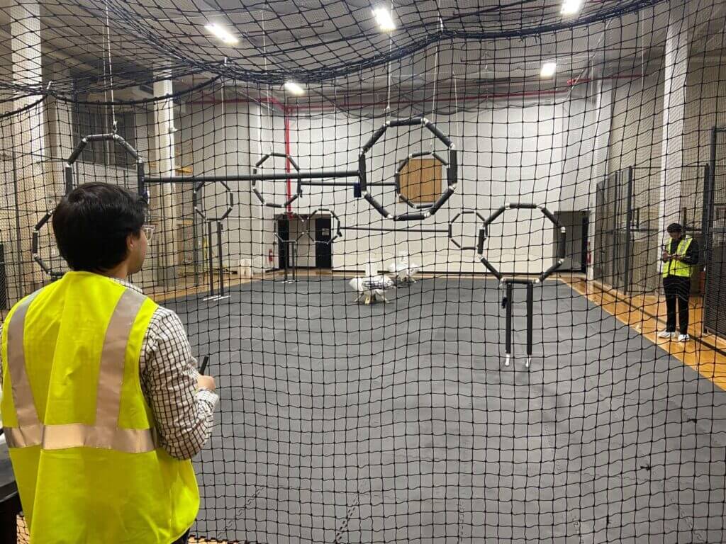 Students at the University of Albany fly drones in an indoor obstacle course