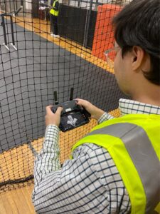 A student holds a drone controller at a drone lab