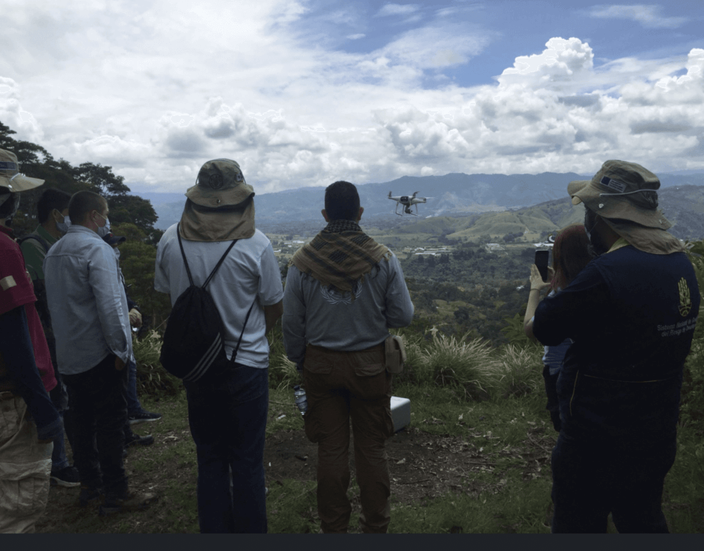Drone pilots fly a drone in Latin America