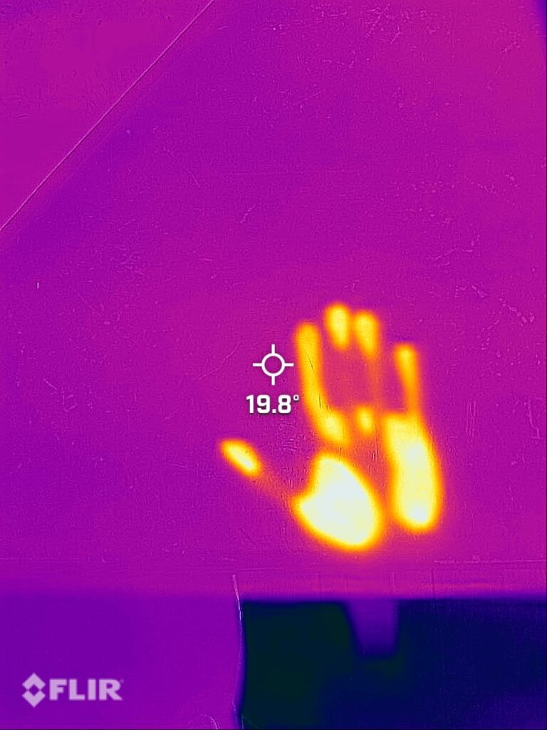 Hand print left on a table shown infrared.